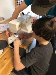 Getting some help on the sewing machines.