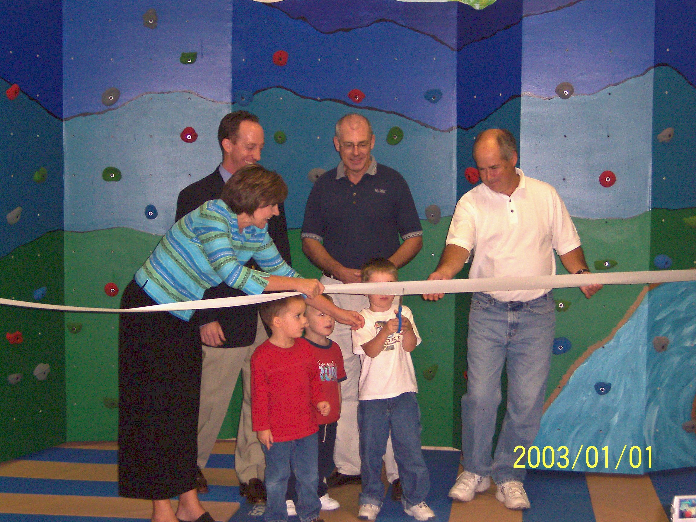  The Shenandoah Valley Builders Association provided funding for a climbing wall. Executive Director Lisa Shull assists kids with the ribbon cutting.  