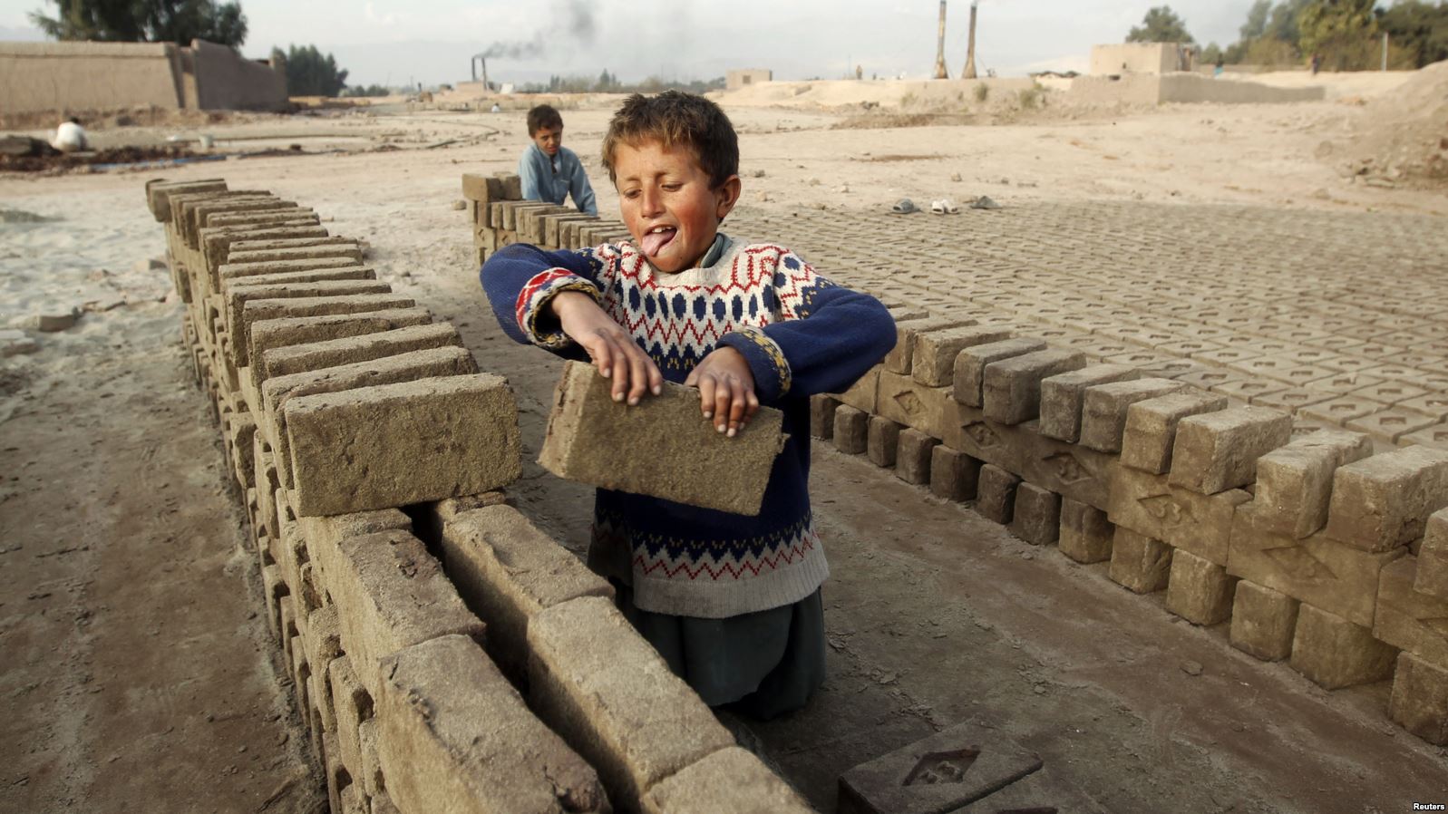 Children work at a brick-making factory in Jalalabad , Dec. 17, 2013.