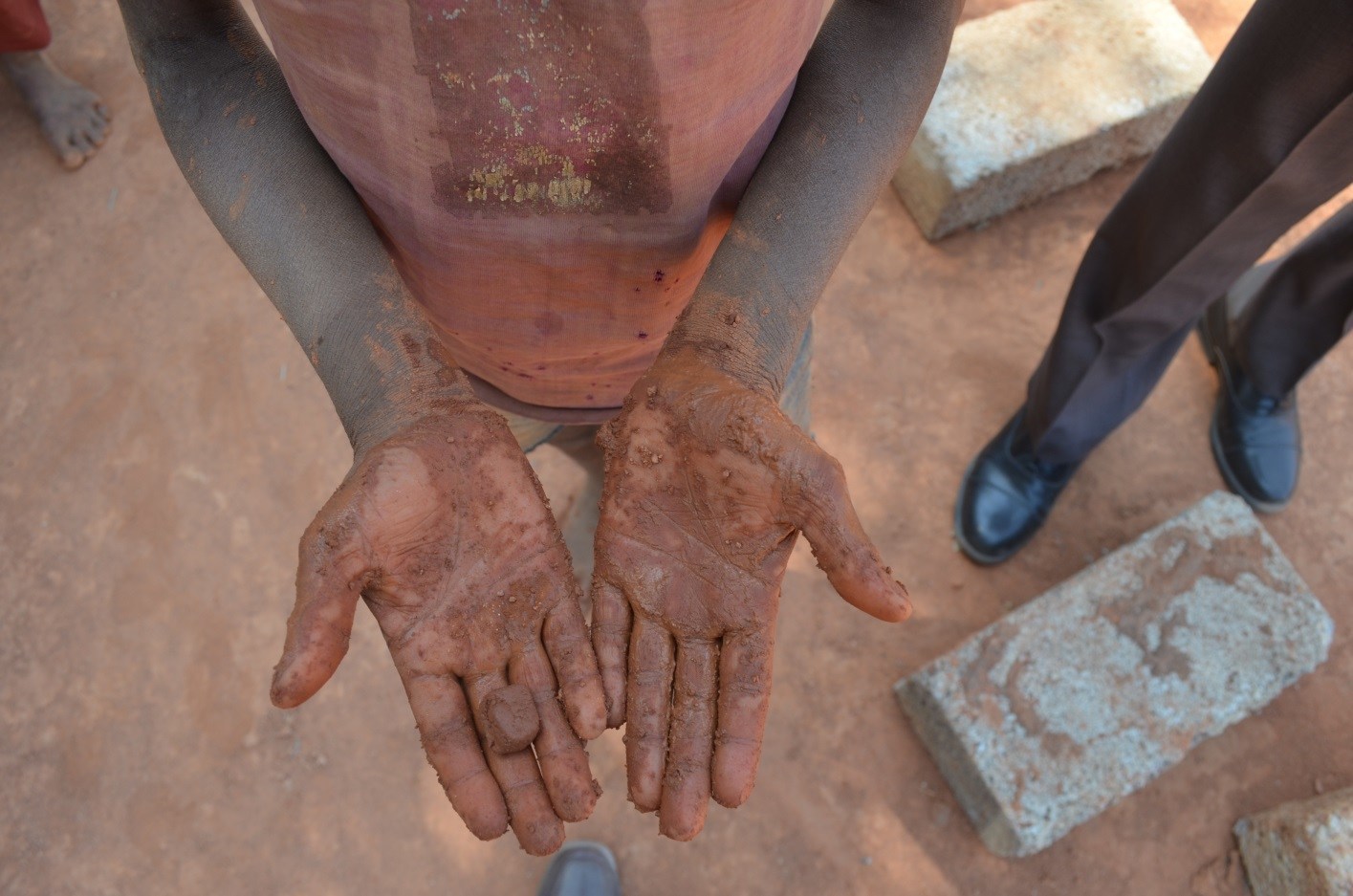 A young child mixes mud to make bricks just before IJM and the Anti-Human Trafficking Unit (AHTU) showed up at a brick kiln near Bangalore to free 25 bonded laborers.