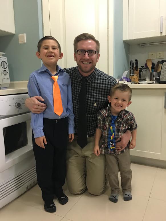 Ryan pictured with his two sons. " They both wore their ties and dress pins to school with me as a sign of their support for Dressember. We encouraged our oldest son, Gavin, to share with others that he is wearing a tie and a pin to raise funds to help those around the world in need. He's in Kindergarten. We haven't broached the subject of slavery with him yet.