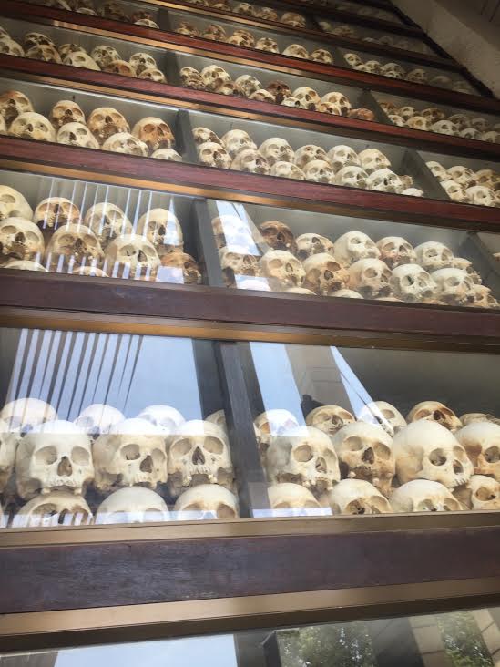 Skulls line the walls of a memorial at "The Killing Fields" in Cambodia where millions were murdered.