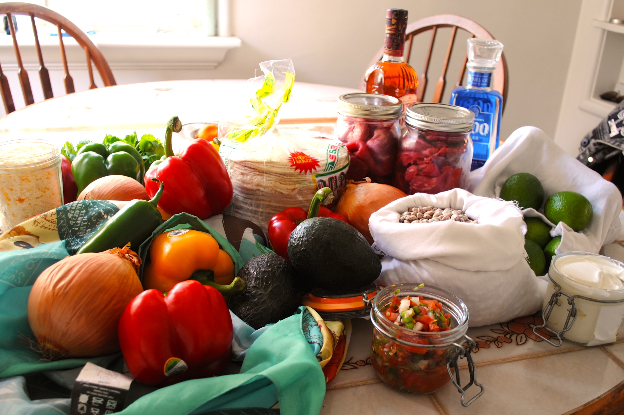 Back from the grocery store. Peppers and Avocados, even though in season, are difficult to find at my farmers market. Unfortunately both items had stickers on them, but the most unfortunate thing of all was the tortillaria being closed. There were no fresh tortillas only leftovers from earlier that day wrapped in plastic. I could have made the tortillas, but I didn’t have time. Next time I will need to plan better. Fortunately I was able to load my jars with sour cream, pico, and shredded cheese.