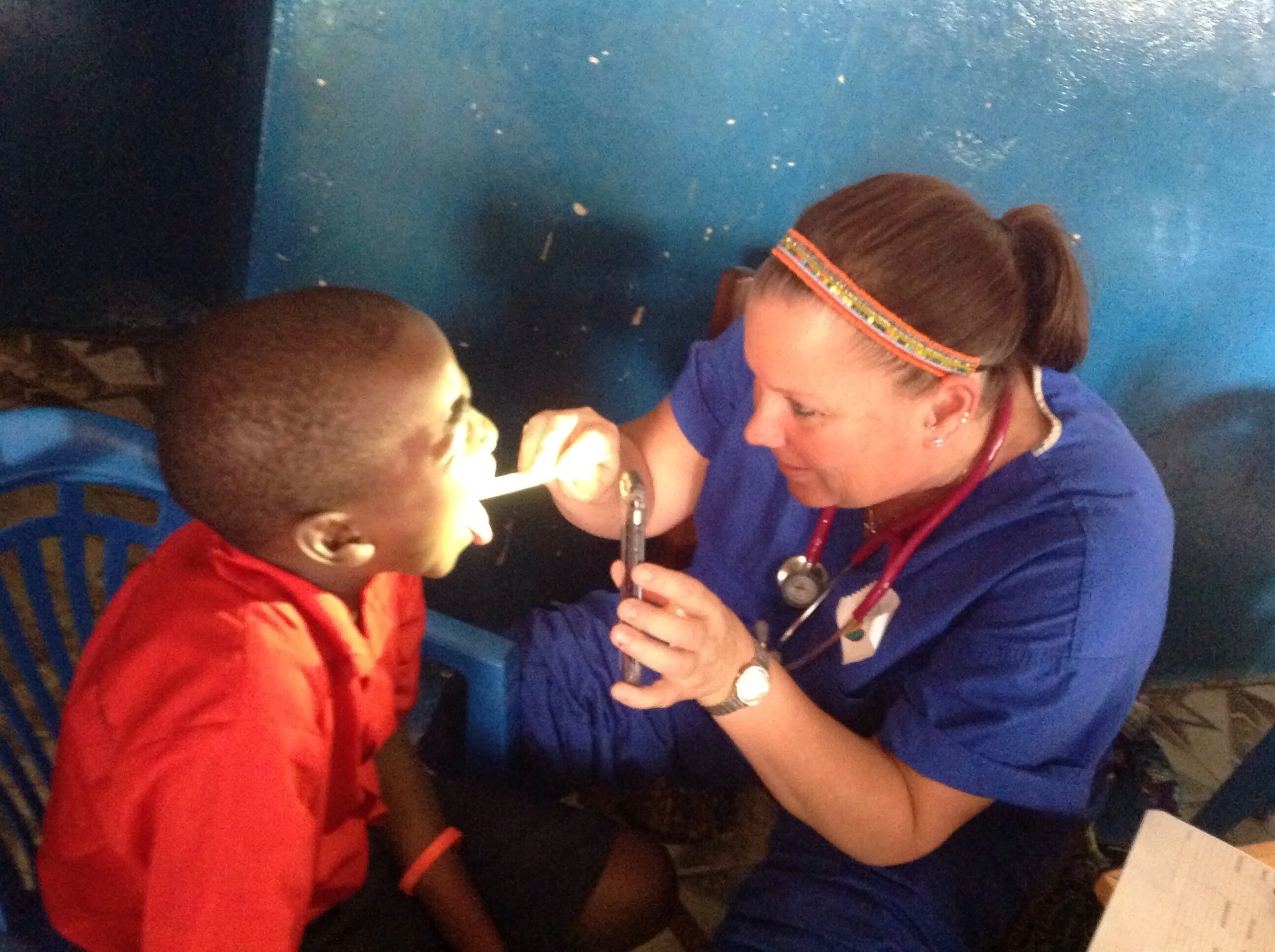 Jen checking the throat of a boy diagnosed with strep throat