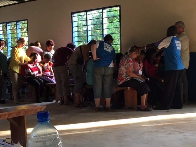 Prayer over our Bomani partners before our final departure.