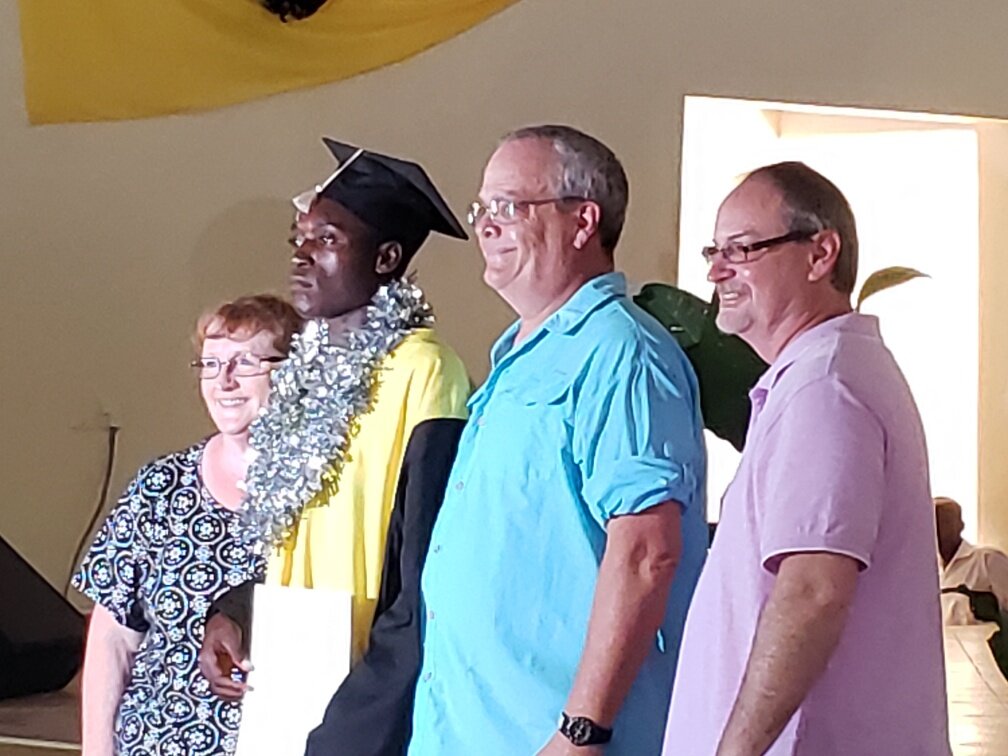 Missionary Bobby Bechtel, Tim and I awarding the certificate of appreciation to Martin, our sponsored boy. He has the top score in business.