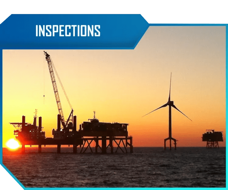 Offshore oil rig and wind turbine at sunset with a clear sky