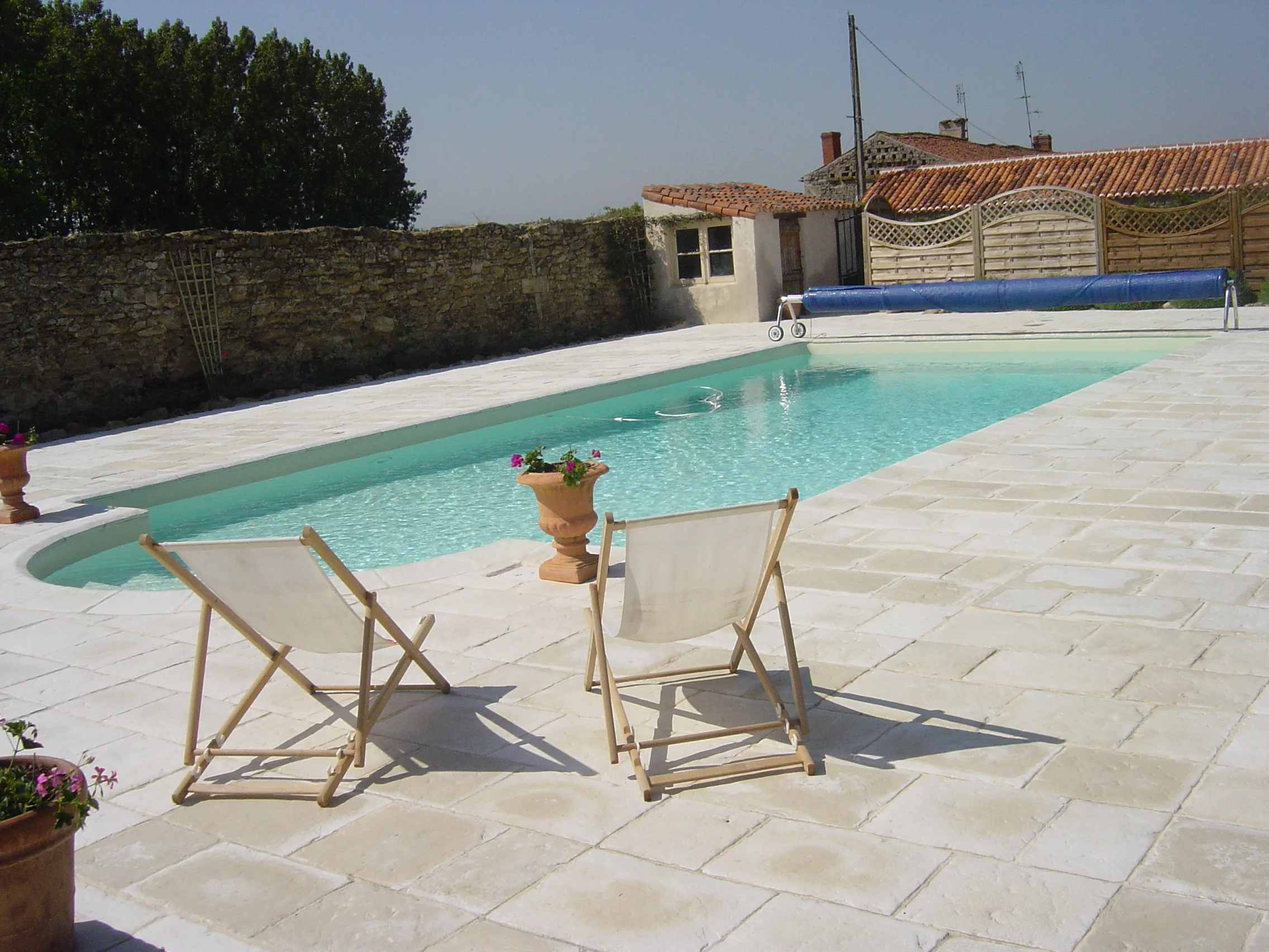 10 m by 5 m in-ground swimming pool with roman steps, sand liner and stone terrace.