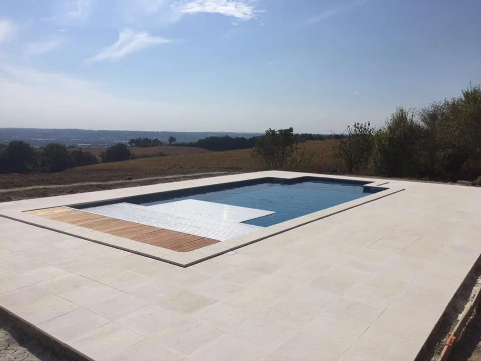 10 m by 5 m pool with rectangular roman steps, byzantine blue patterned liner, stone terrace and immerged security cover.