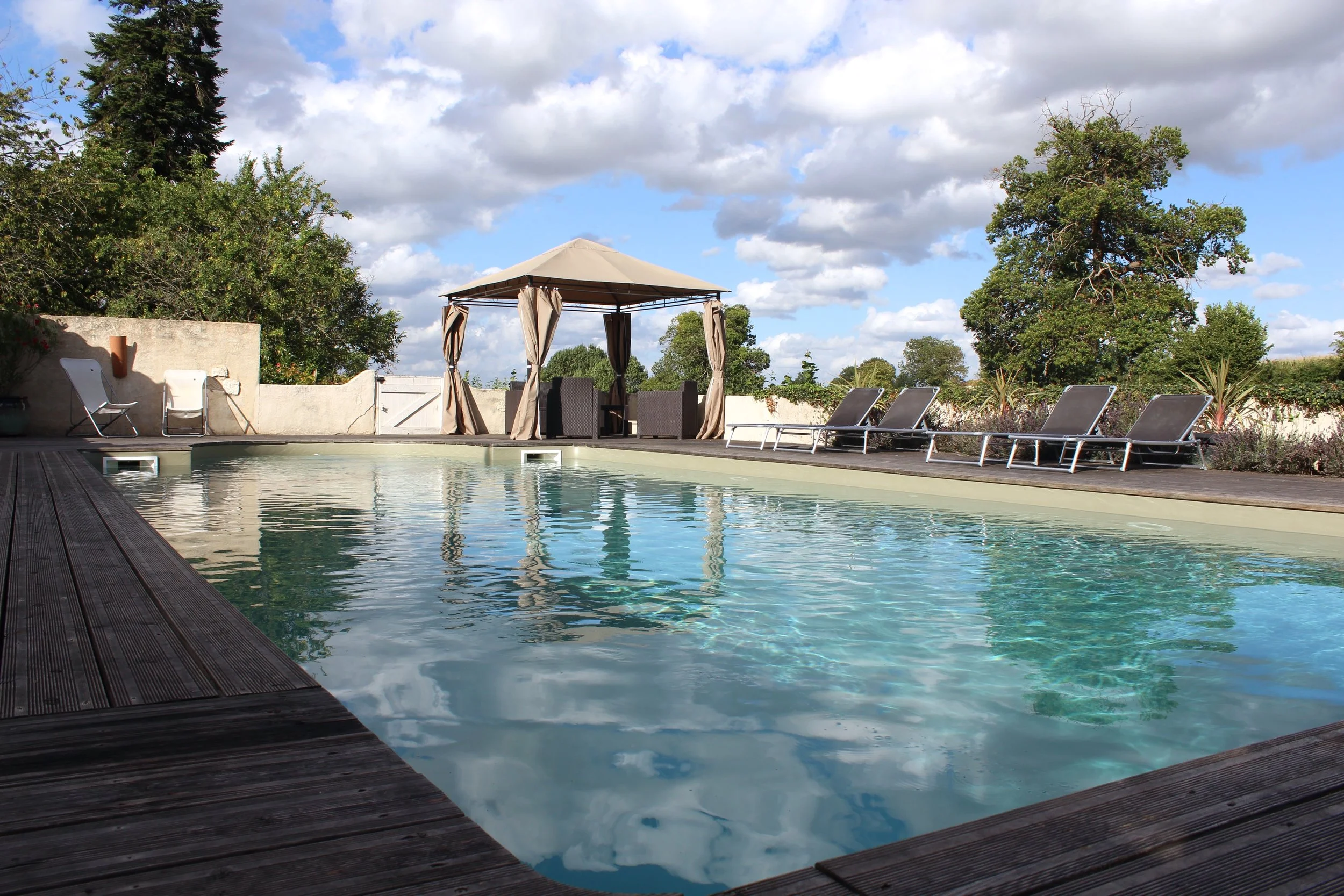 10 m by 5 m in-ground pool with olive green liner and decking terrace.