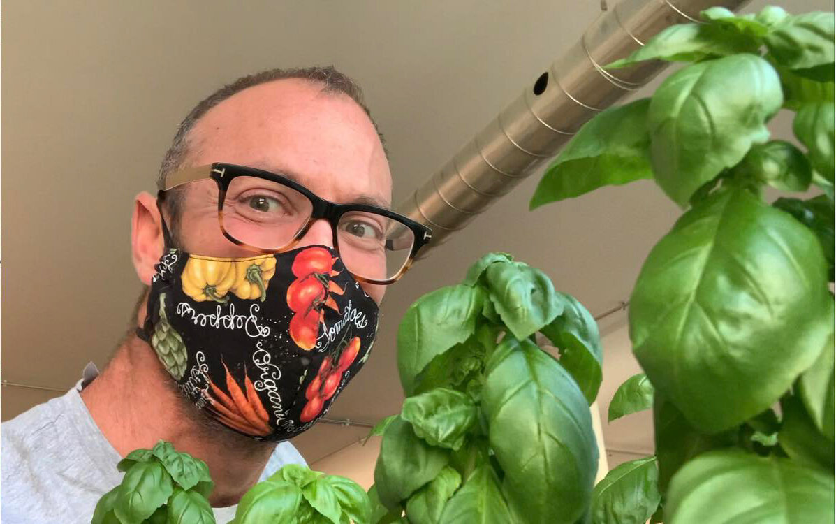 South African native, Janus Swanepoel dons a mask recently sent to him from friends. Janus grows microgreens, herbs, and small vegetables in his urban space in Chicago for sale to the general public and restaurants. Follow him on Facebook at @towncr…