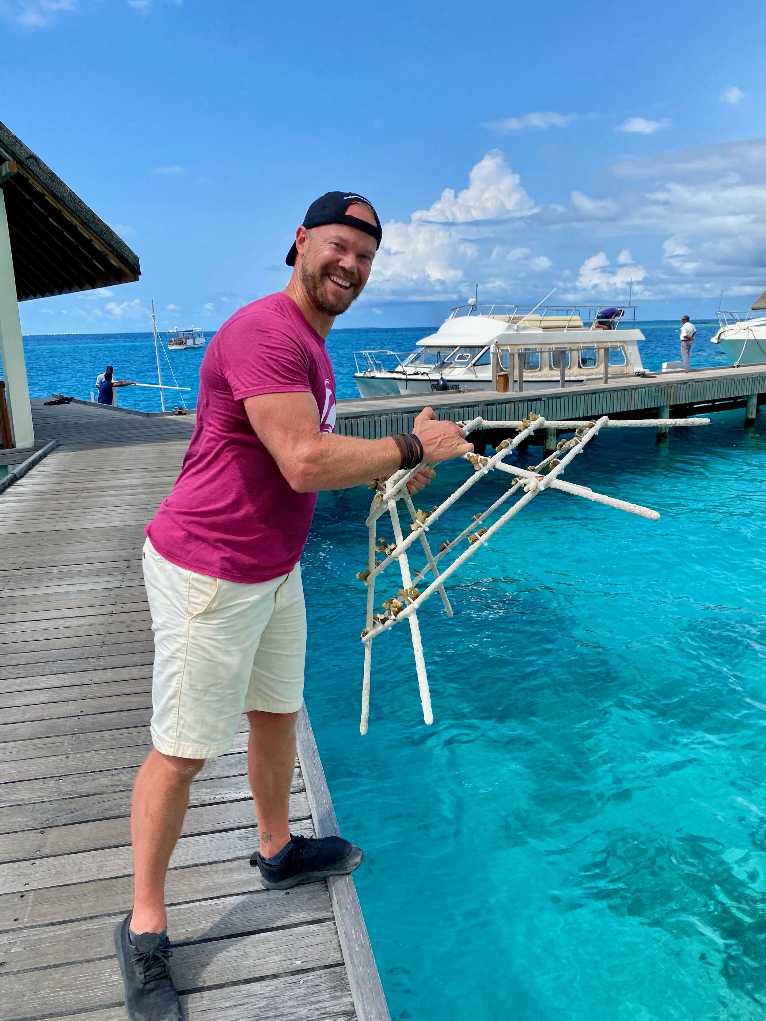 Zoom Vacations Co-Founder, Bryan Herb gets ready to drop the Zoom Vacations coral reef frame into the ocean.