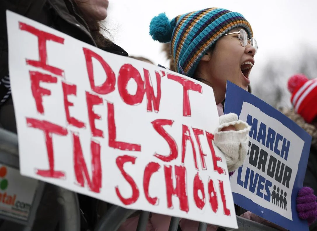 Protestors chant during the March for Our Lives rally on March 24 in Chicago. More than 800 March for Our Lives events, organized by survivors of the Parkland, Fla. school shooting on Feb. 14 that left 17 dead, took place around the world to call for legislative action to address school safety and gun violence. (JIM YOUNG / GETTY IMAGES)