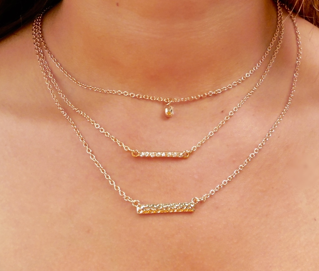 Dainty stackable necklaces. Hammered rectangular bars and one zirconia pendant