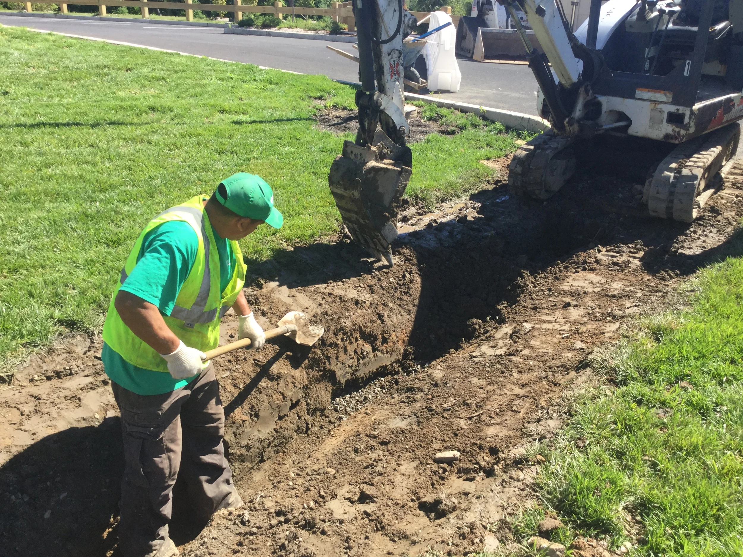 Grasskeepers Landscaping laborers and operators work together to complete the drainage and sub drainage work required for the project's completion.