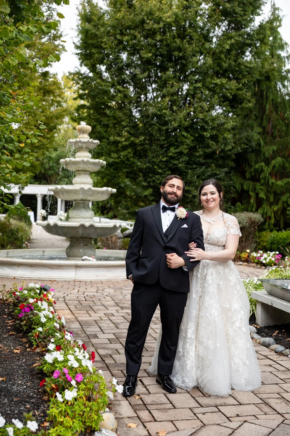 Happy Couple on wedding day at the waterfall wedding venue in the summer