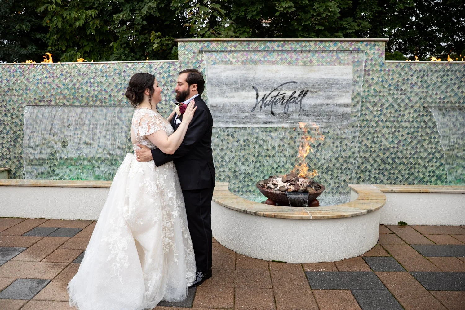 Bride and groom on summer wedding day at the waterfall in Claymont New Jersey