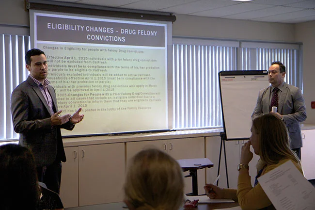 Albert Garcia and Ismael Lopez from the County Health and Human Service Agency present on changes to eligibility guidelines as result of lifted drug felony ban at February 26 th CalFresh Task Force meeting. (Photo by Kimberly Powers)