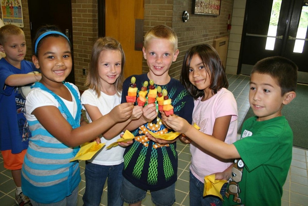 Children enjoy fruit at a summer meal site