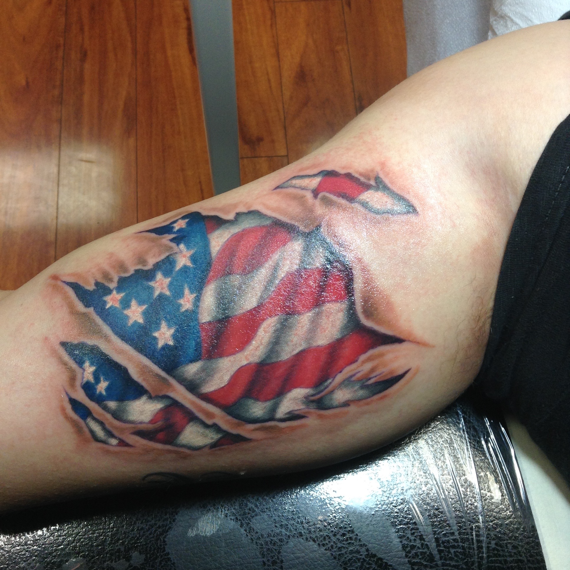 Ripped Skin US Flag Tattoo On Left Shoulder