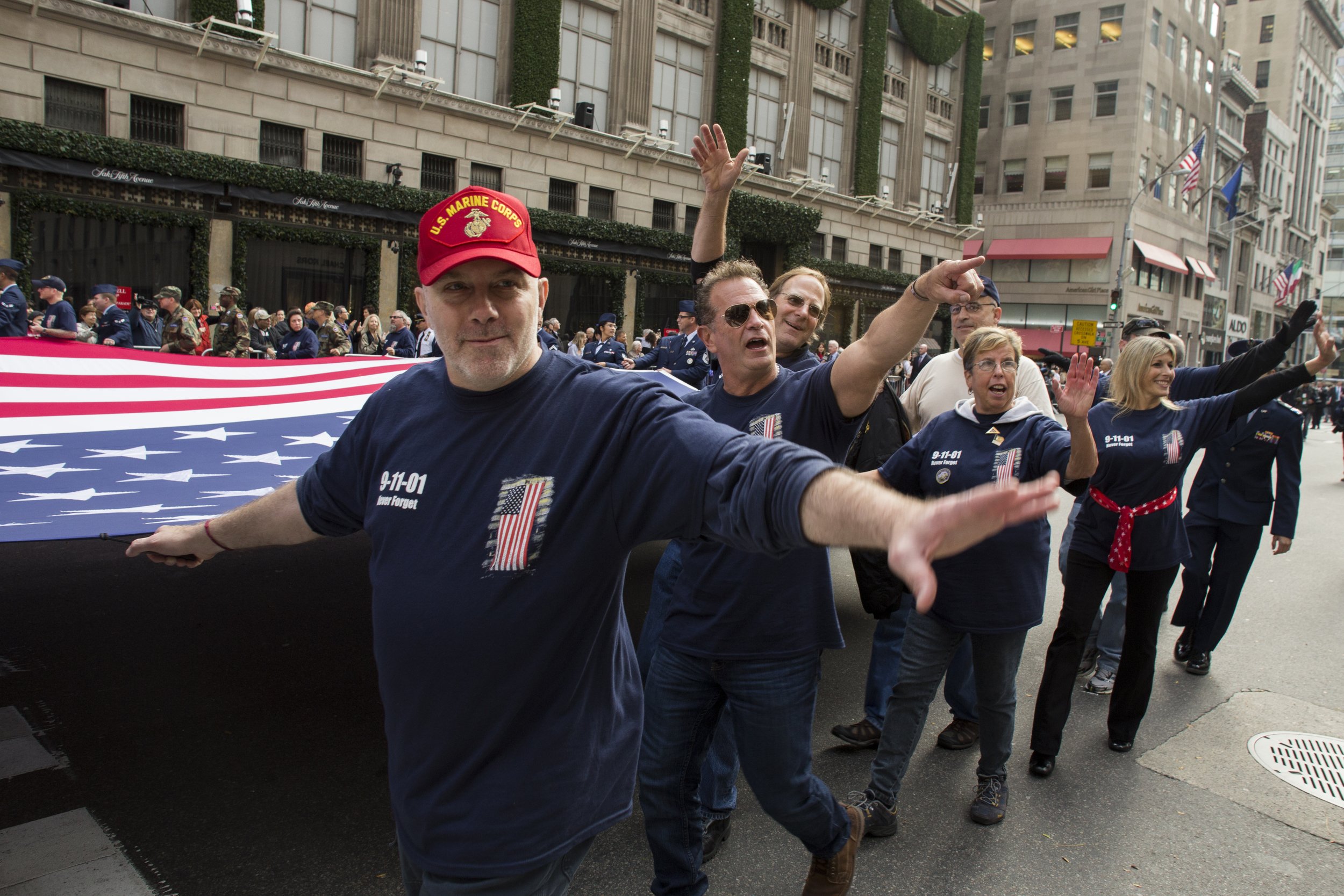  Firefighters carry a large American flag down 5th avenue during the 2015 Veterans' Day parade.&nbsp; 
