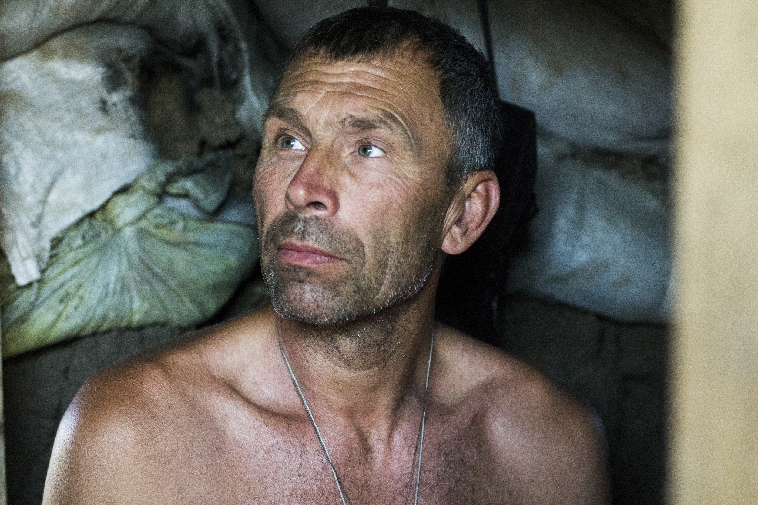  Anatoli Ovdeechook, 52, a Ukrainian fighter known as "Viking," shelters from the sun in a bunker overlooking the embattled southern city of Shyrokyne, Ukraine in July, 2015.&nbsp; 