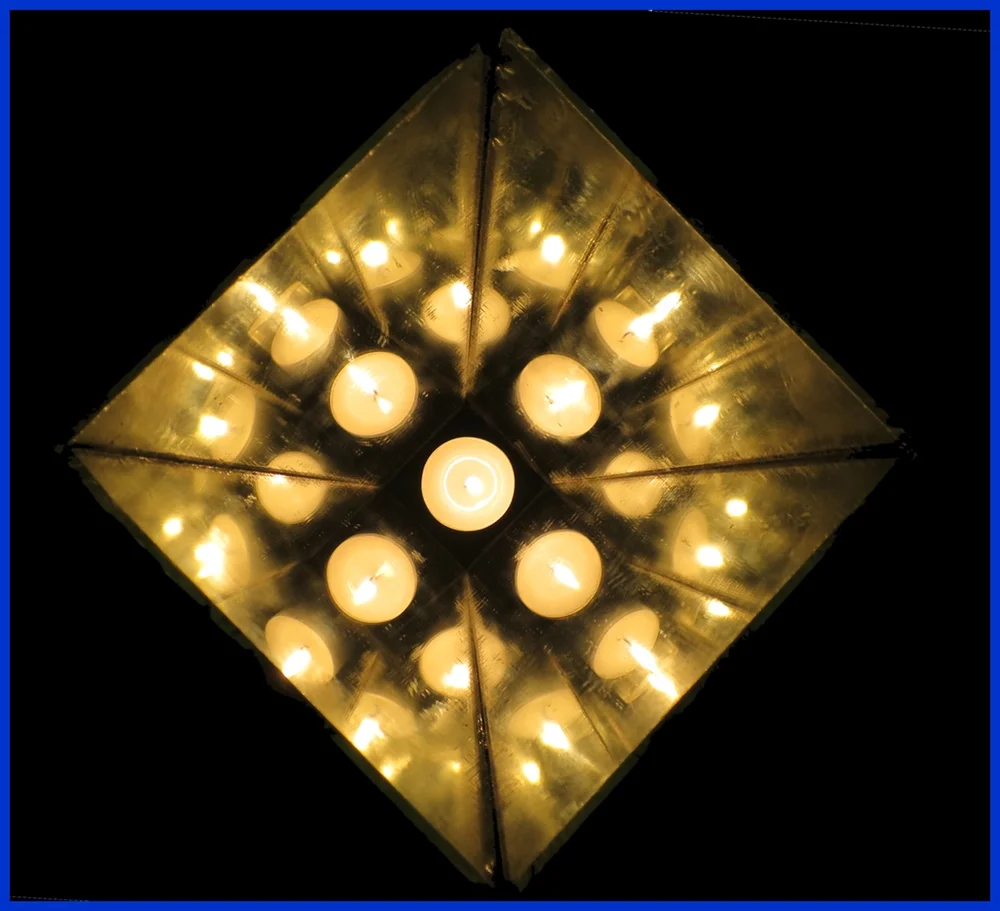 The Albertan Nocturnal Star. This installation is comprised of four trapezoidal mirrors with a single candle placed at the centre base.