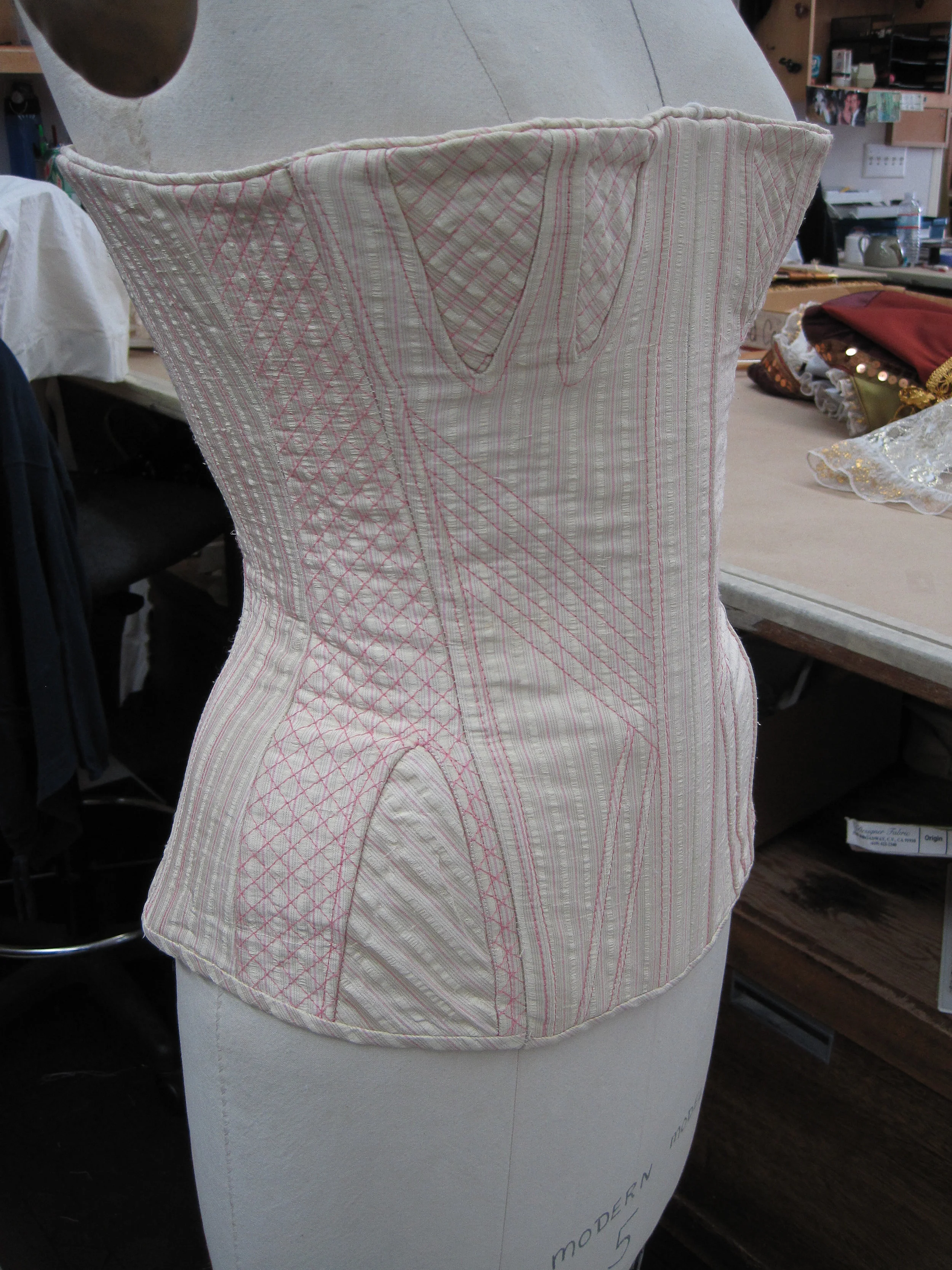   corset with fashion fabric flatted over coutil, featuring decorative quilting, hip and bust gussets, piping finish at top and binding finish at hip   Much Ado About Nothing/ The Old Globe/2011 design by Deirdre Clancy/draping by Louise Powers 