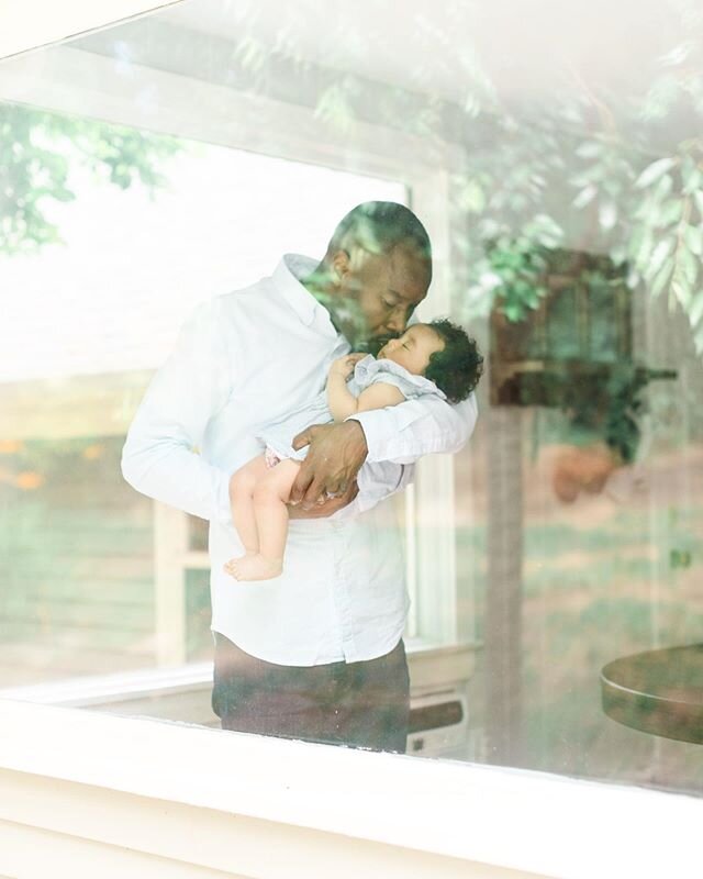 This sweet family recently moved into a new home and I just love this peaceful image of Dad holding his sleeping baby girl through a glass window.