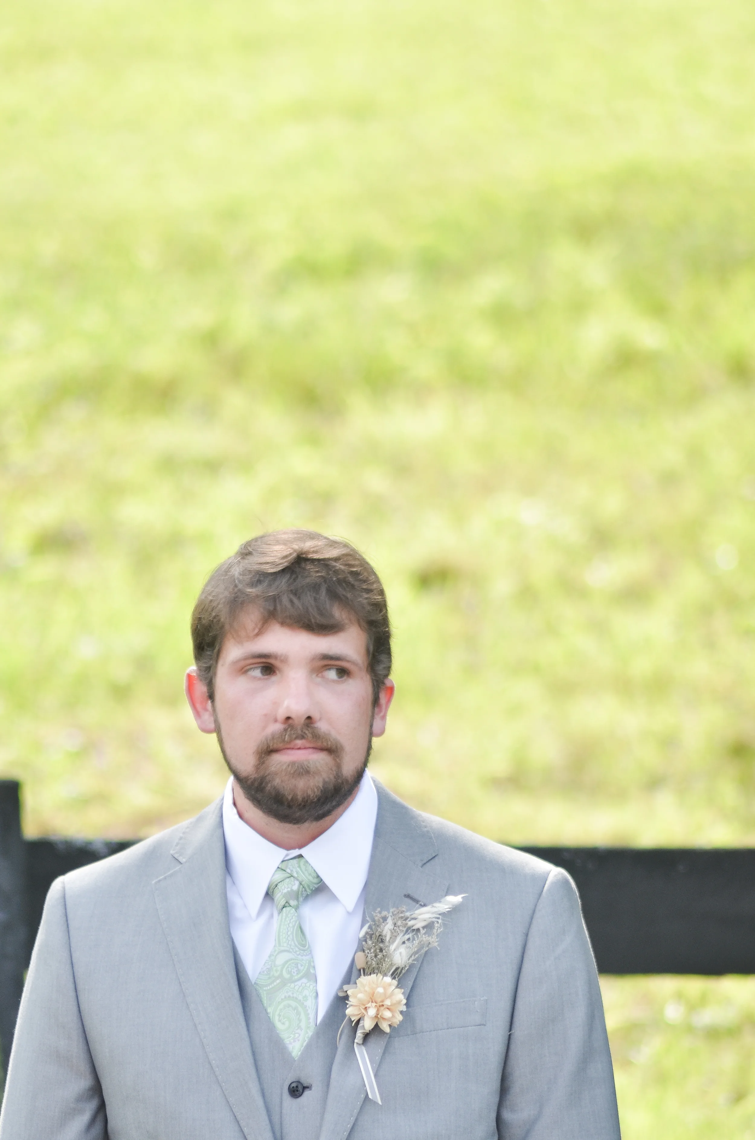 Photocredit: Kirsten Smith The paisley tie and unique boutonniere really pop against this gray suit.