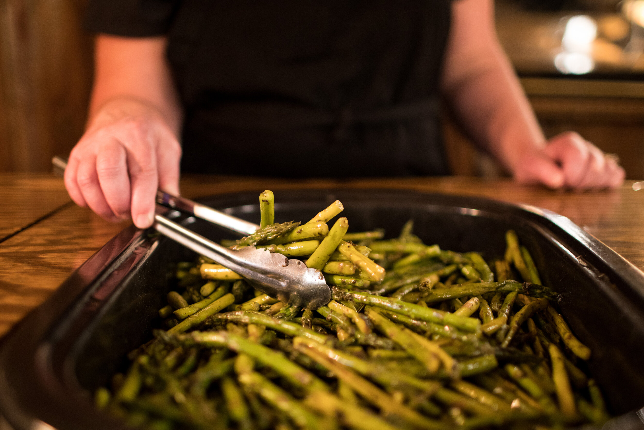 Serving dishes are built into the counter, with staff behind. The staff makes your plate, so guests never touch the food.