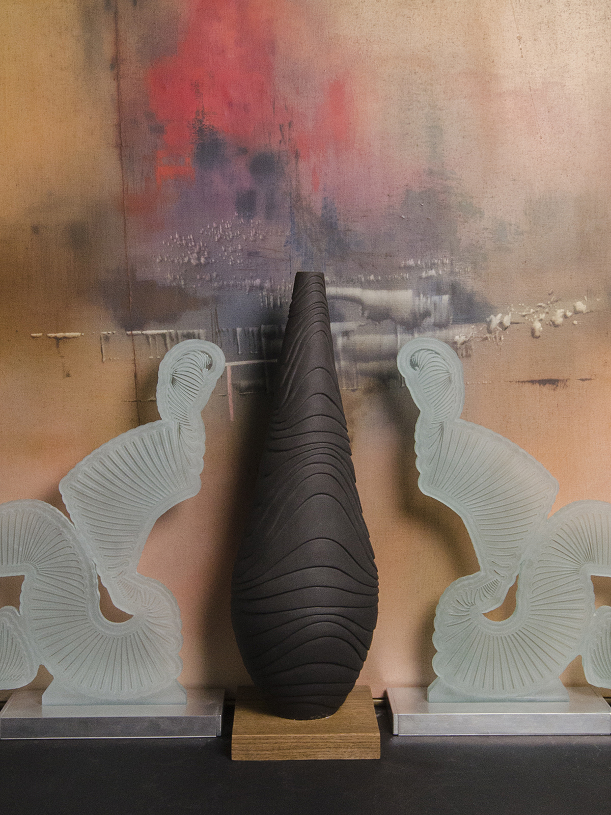 Featured here are a painting in the background by British artist now living in Toronto, Canada Ray Cattell. In the foreground and centre is a ceramic vase by Loren Kaplan and to each side are glass sculptures called 'The Sisters' by Pierre Bouchard.