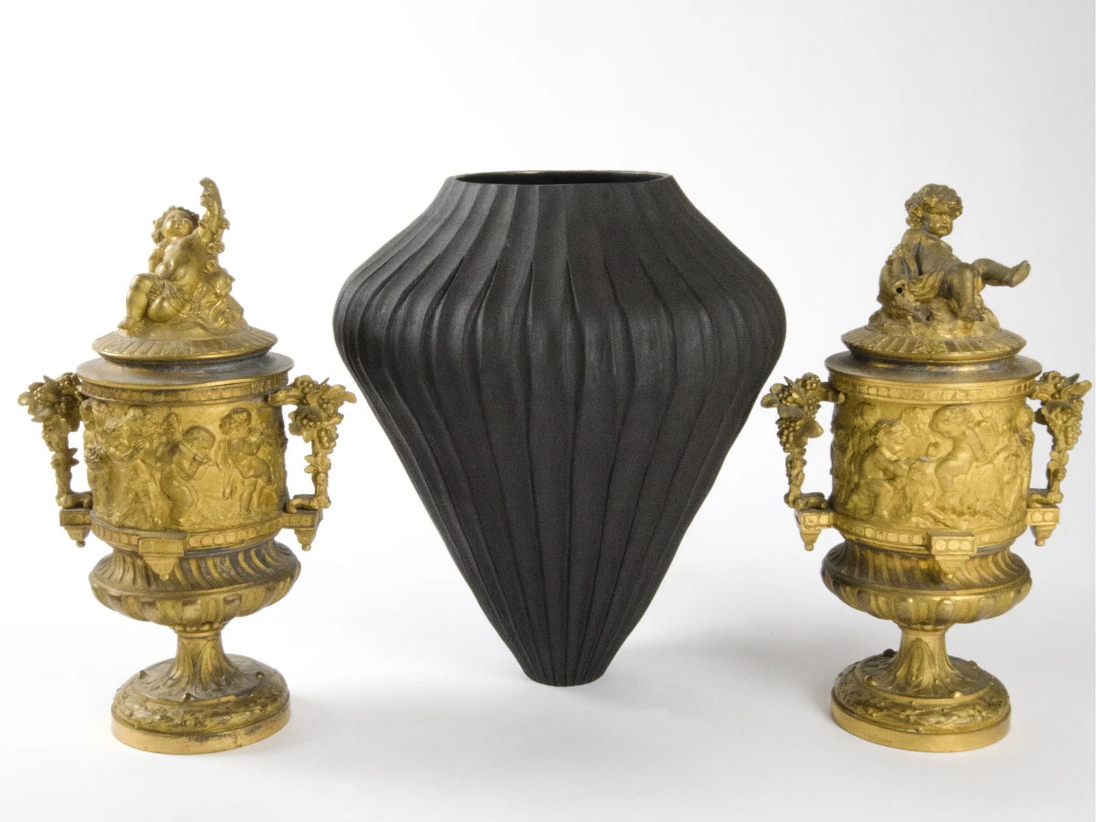 Ceramic vase by Loren Kaplan and 19th century gilded bronze urns.