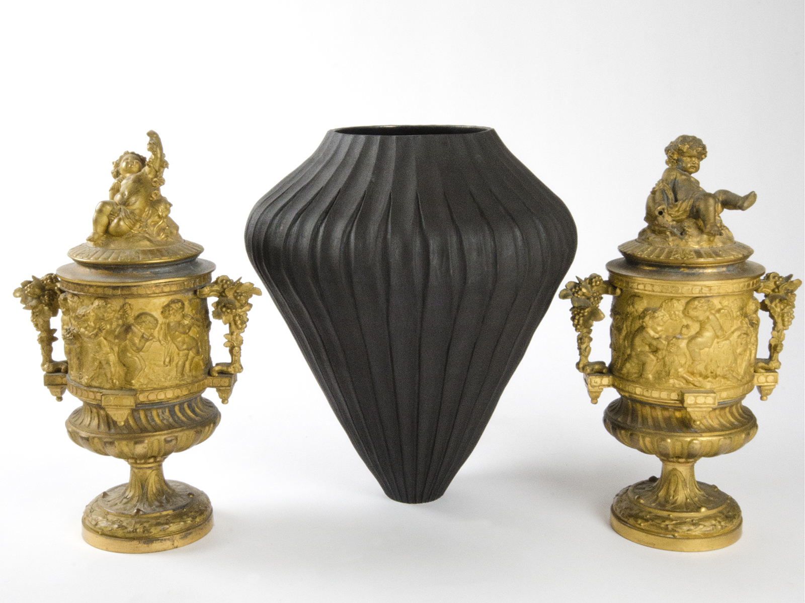Ceramic vase by Loren Kaplan and 19th century gilded bronze urns.