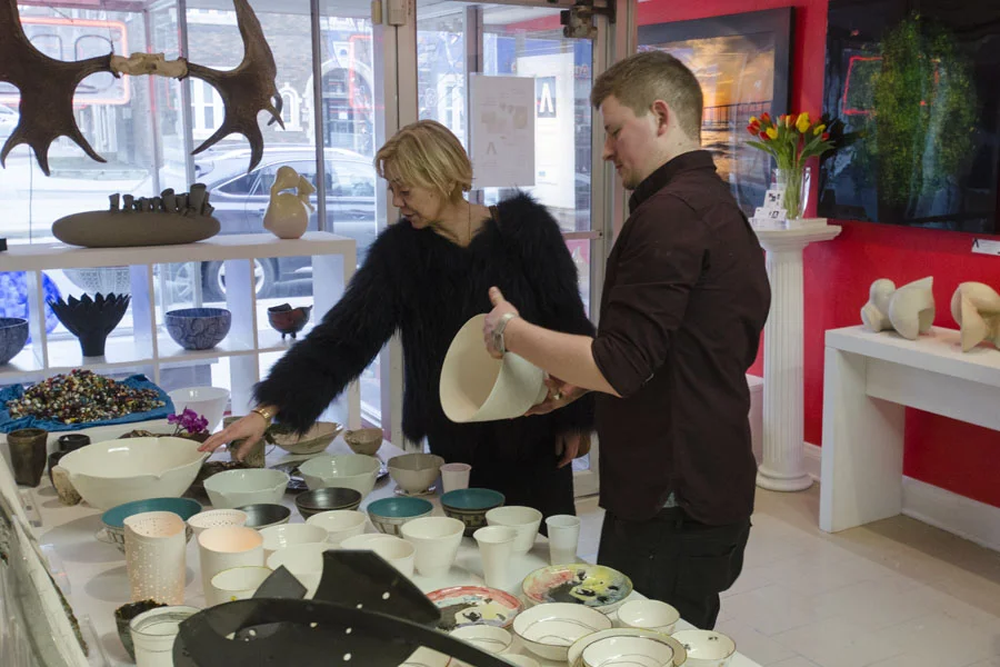 Fran Hill looking over some ceramic bowls by Filipa Pimentel
