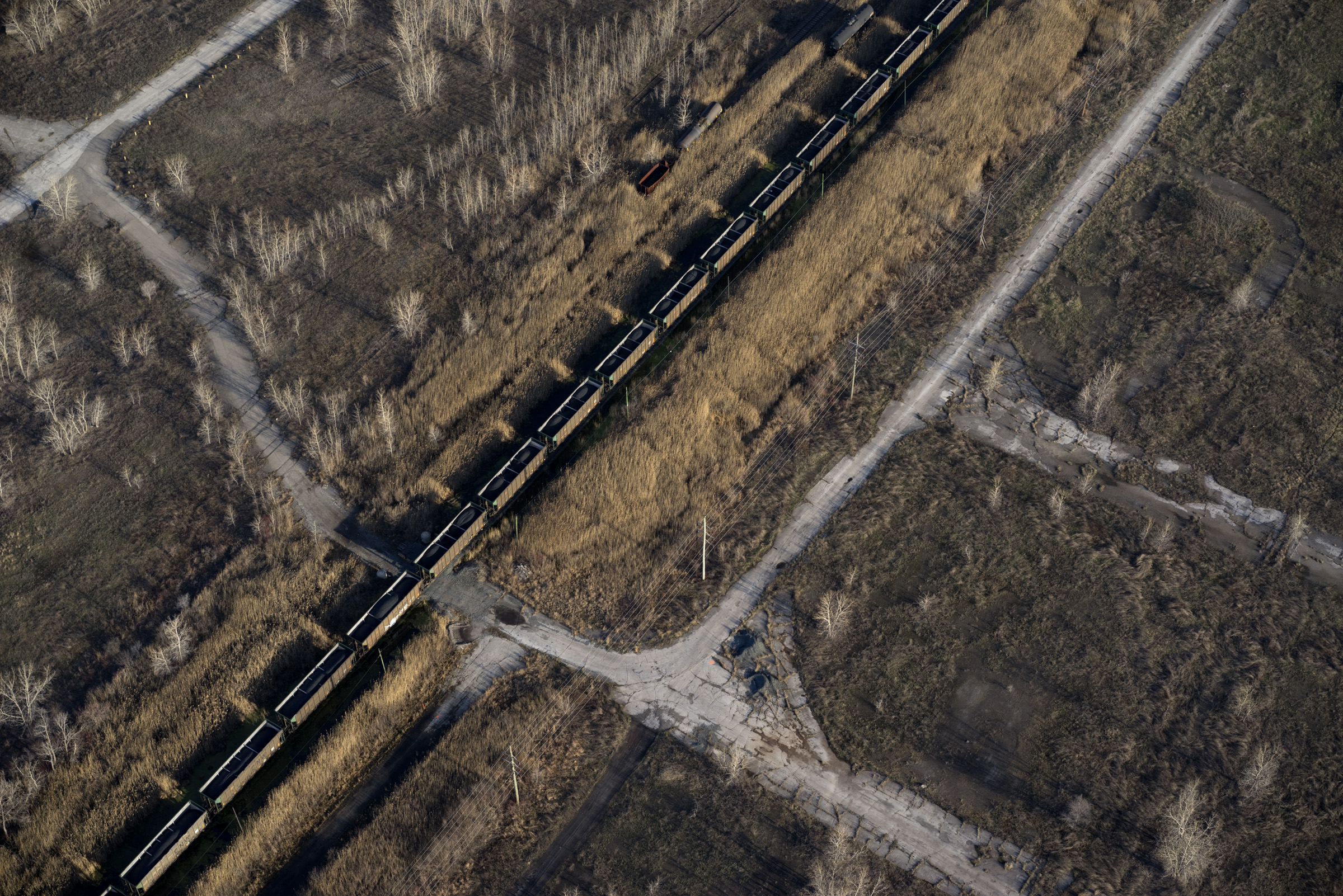 Petcoke filled train moving through a brownfield, former steel mill site, 2014. Terry Evans