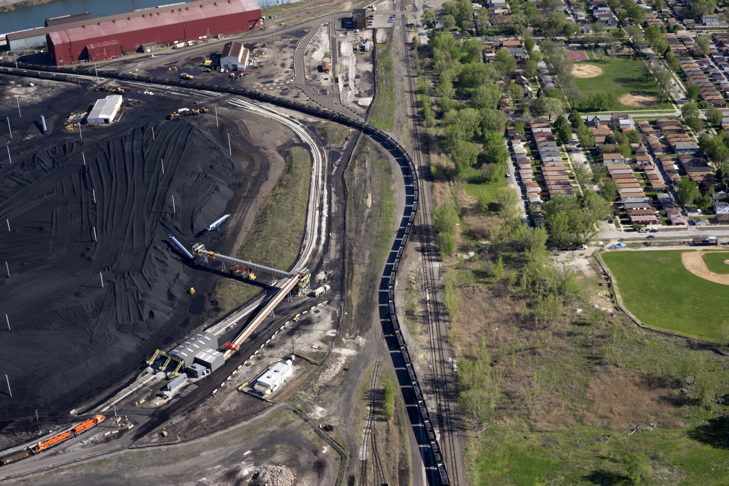 Petcoke filled train snaking through the neighborhood, Southeast Side, Chicago, IL 2015. Terry Evans