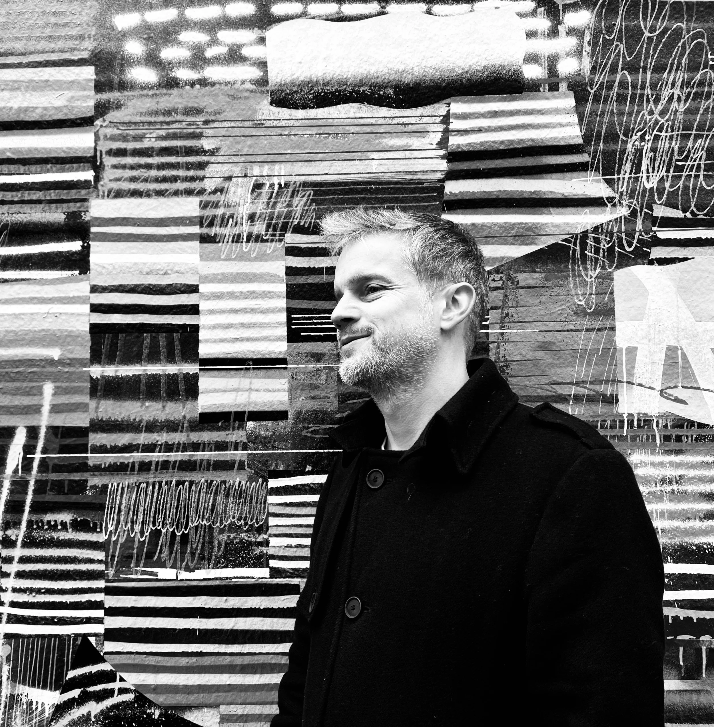 David Menke standing in front of a wall
