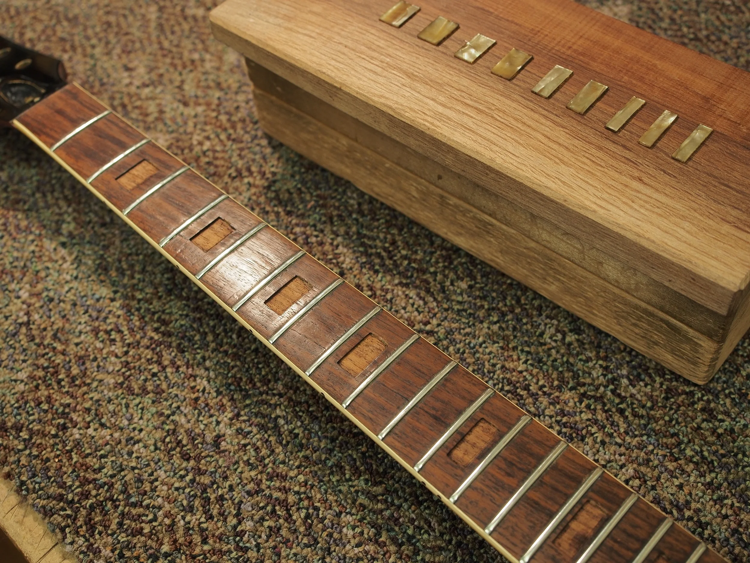 The neck removed, and the block inlays removed, and set aside for later use. 