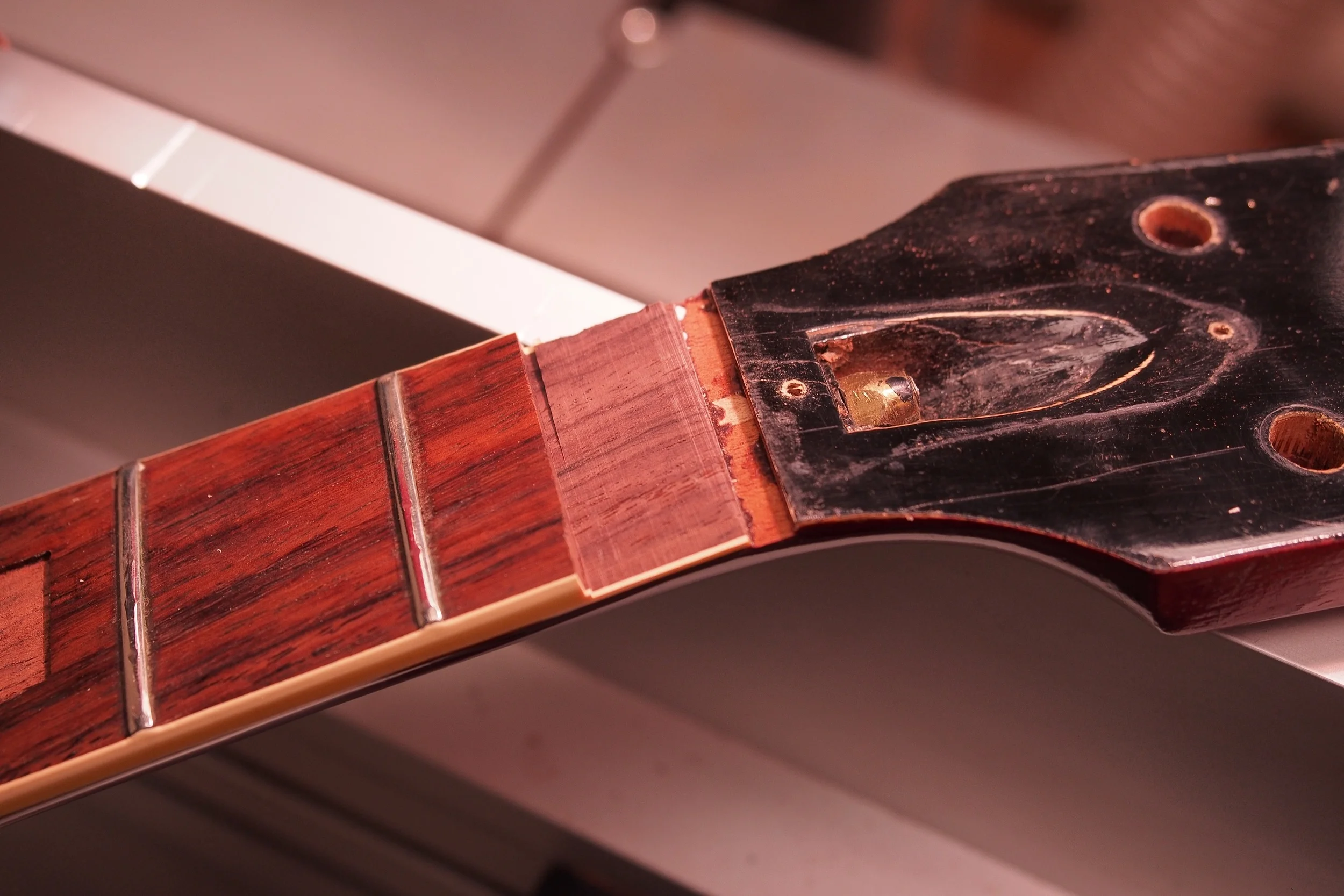 Ok, yes, this picture at first appears sinful, but not if you know all the details. As I said in the first blog, Part 1, this neck has already been modified from original. Second, the idea is to replace the neck with something matching the larger neck profiles from 63/64. So, it had to be done. The idea is/was, to keep all the original inlay: the "Gibson", the Crown, and the blocks. I got the blocks out last week. So today, I started a little facelift...