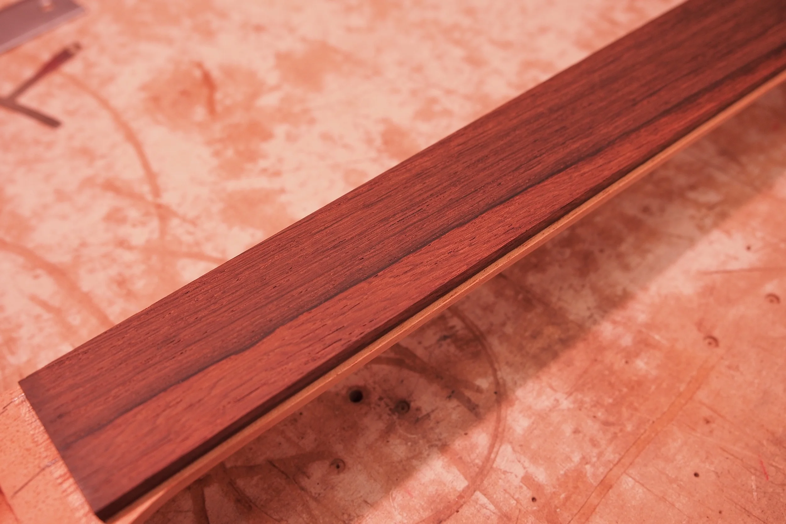 A nice shot of the new fingerboard. It's sized down, and ready for the binding, which I should have in a few days. Once I get the new binding and truss rod, it will be time for neck assembly, final neck shape to 63/64 specs, finish, and final body/neck assembly. More pictures to come!