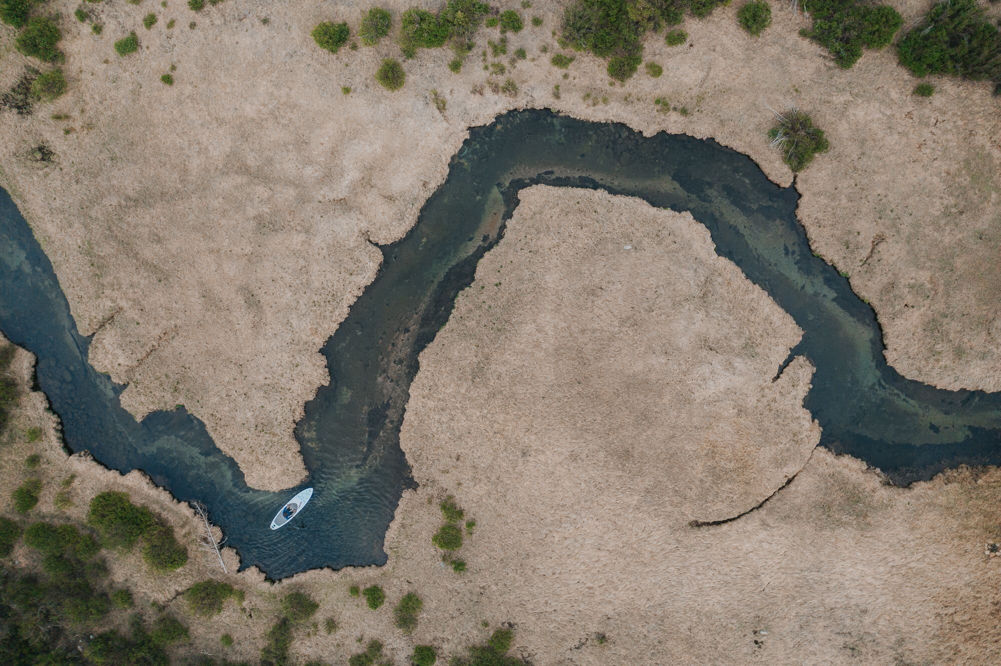 aerial view of an Atoll inflatable paddle board on a river stream