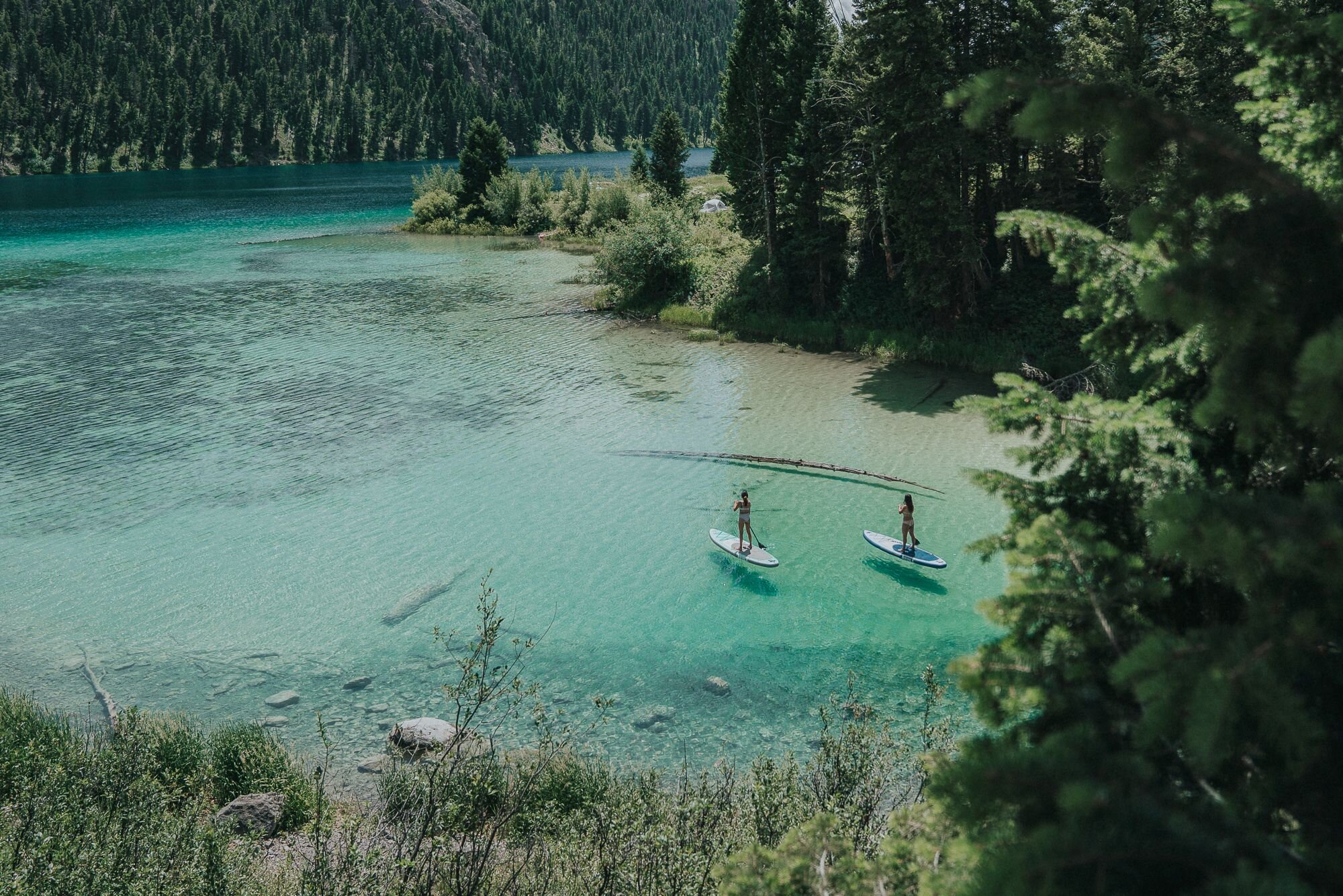 Aerial view of lake with Two girls paddling