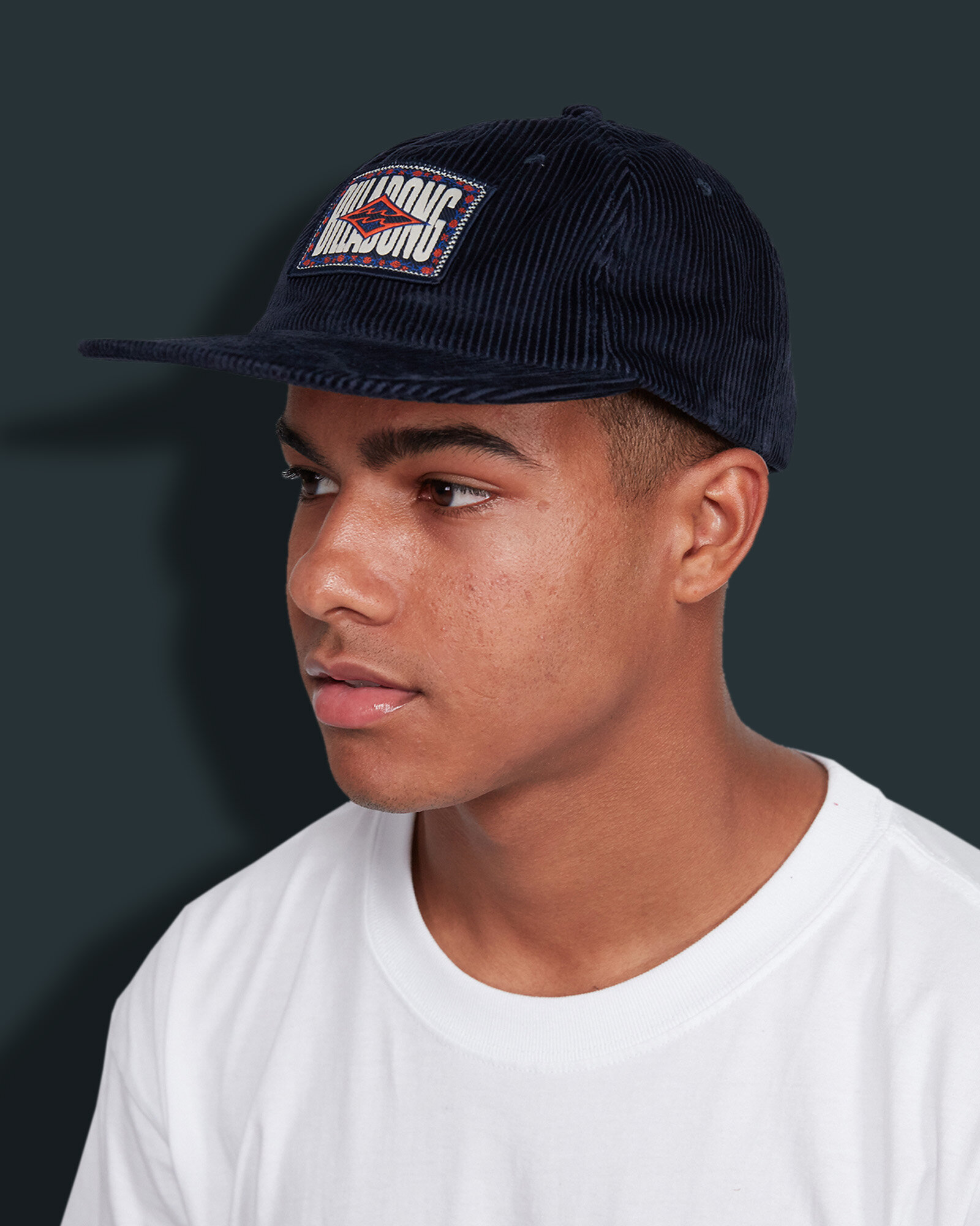 Corduroy buckle hat with woven patch art and nylon taping detail