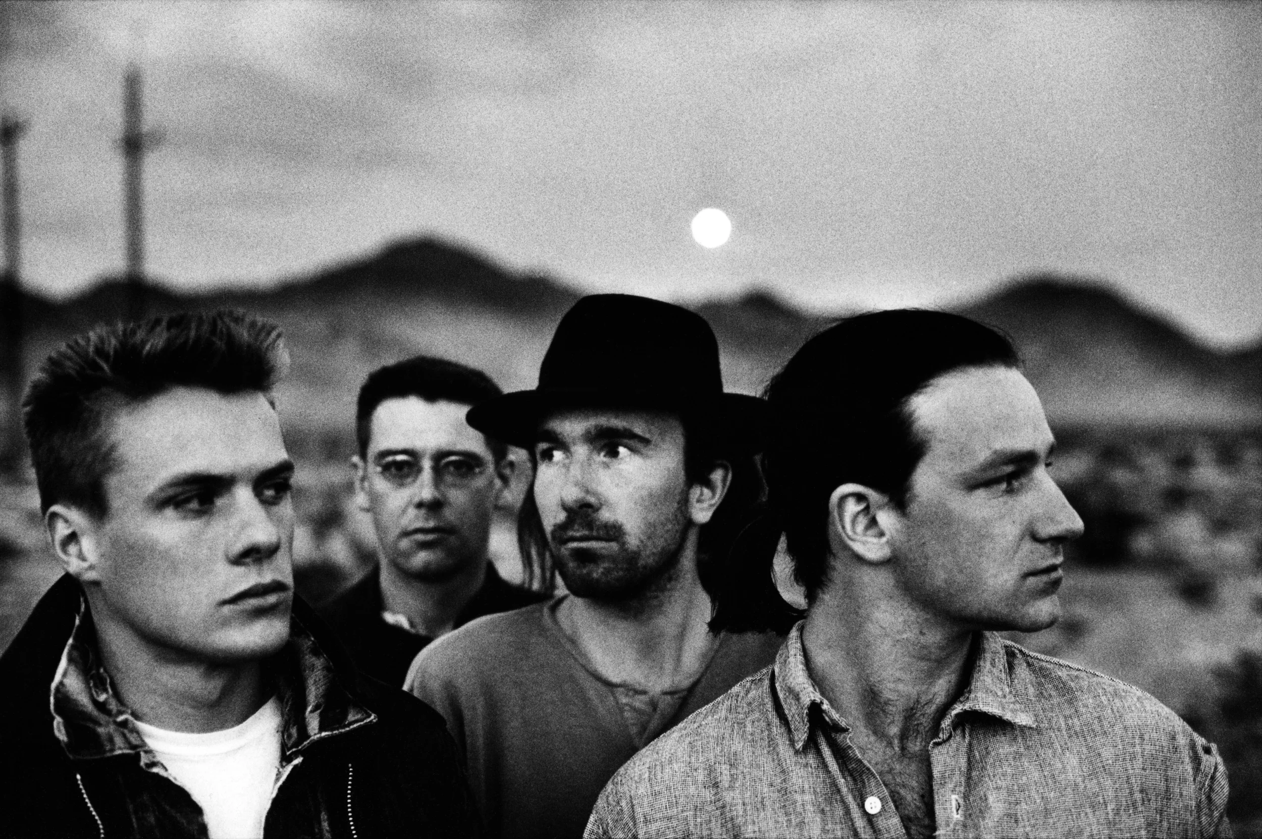 Bono is the guy on the right. All four lads are wanted for postal fraud in connection with a scheme to reproduce rare Irish stamps commemorating the birth of Paddy Finnegan, a.k.a. McPaddy. Shortly after this photo, Bono began wearing sunglasses indoors.
