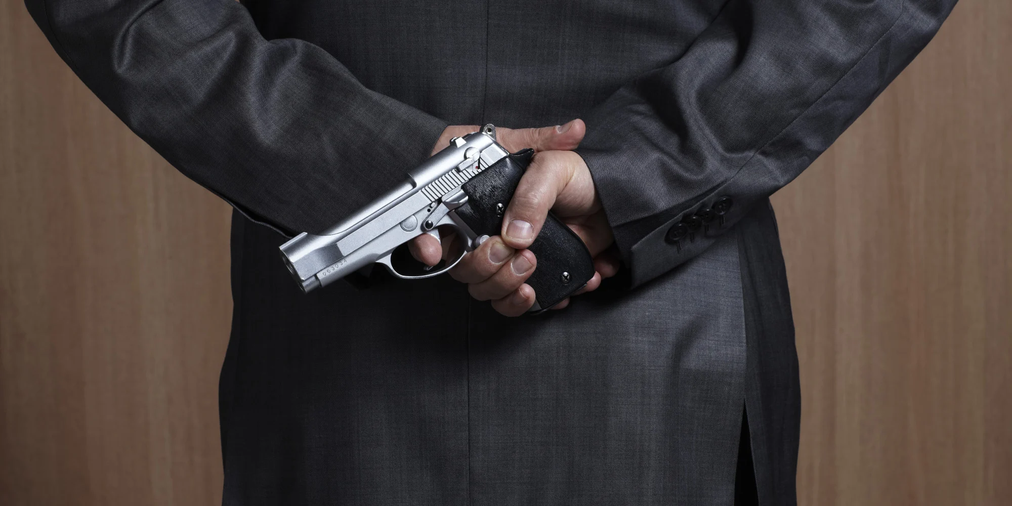 A man in a dark suit with a gun behind his back, saying he is here to help me. I'm not James Bond (or am I?) but this doesn't feel right.