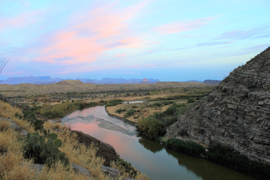 Emerging from the canyon, the day’s final light reflected red off the river and onto the valley below.