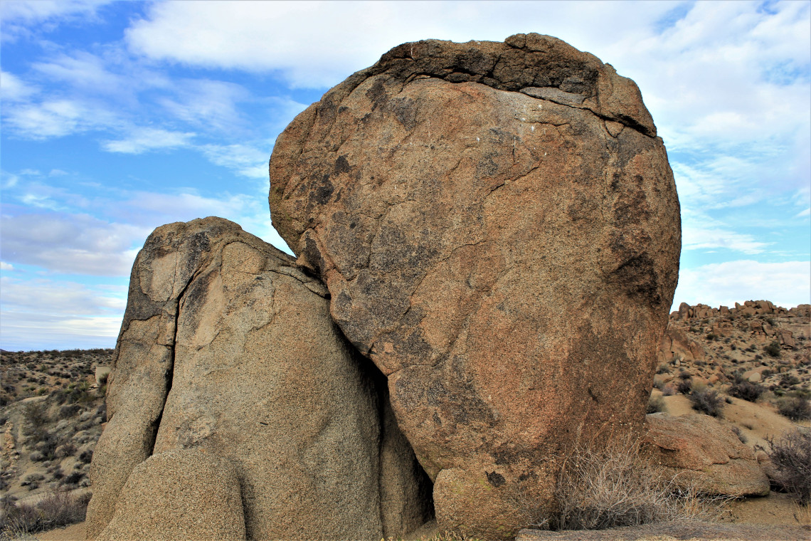 First I thought of two rocks in love. Then a larger, weaker rock, leaning on a smaller, stronger rock. Then I saw the side of my head leaning against a fish.
