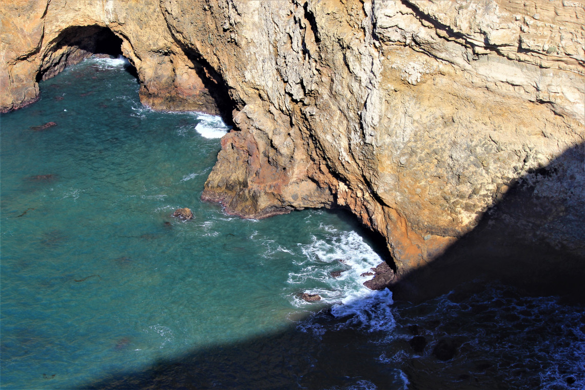 Caves cut into the volcanic rock of Potato Harbor.