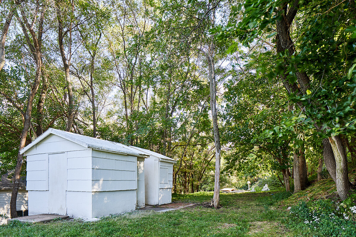 SHED 10 . 04 . 2019 Existing 100 year old shed, cut and sprayed with marble dust and acrylic. “Non-referential buildings are entities that are themselves meaningful and sense-making and, as such, no less the embodiment of society than buildings were in the past when they were the bearers of common social ideals.” - Valerio Olgiati, Non Referential Architecture You are walking this line in the landscape, to your right resides a nurtured plot with manicured turf and wildflowers confined by mulch and brick. To your left the grass grows high and unkept, wildflowers land in the breeze. To your right a house of nostalgic symmetry and painted shingles. To your left a collage of planes, maybe a wall, maybe nothing. To your right the landscape is objectified with comfort and acceptance, to your left uncertainty and vulnerability. A few steps ahead one finds a shed that only the landscape remembers. might mean nothing might mean everything invisible until found abstract until objectified a moment of utility confined by the landscape revealed through wonder a path was made no longer a shed